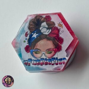 Hexagon-shaped resin grip with Puerto Rico flag design in glittery blue background, styled for phone or Kindle use.