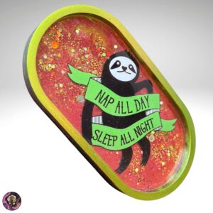 Handmade resin sloth trinket dish with “Nap All Day, Sleep All Night” banner in green ribbon, perfect for jewelry or small accessories
