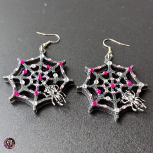 Gothic spider web earrings with red resin accents and stainless steel hooks, handmade by Poxy Rose for Halloween and spooky fashion lovers