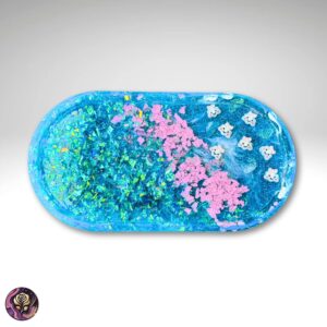 Blue glitter cloud-shaped resin tray with shimmer and pink accents, used as a jewelry or trinket organizer