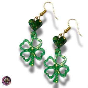 Pair of handmade green resin clover earrings with gold hooks and dark green heart accents, displayed on white background for St. Patrick's Day or boho wear.
