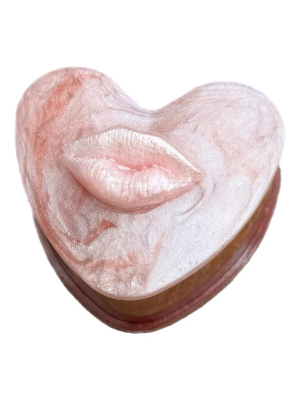 Heart-shaped resin trinket box with pearly lip lid in pink and red tones