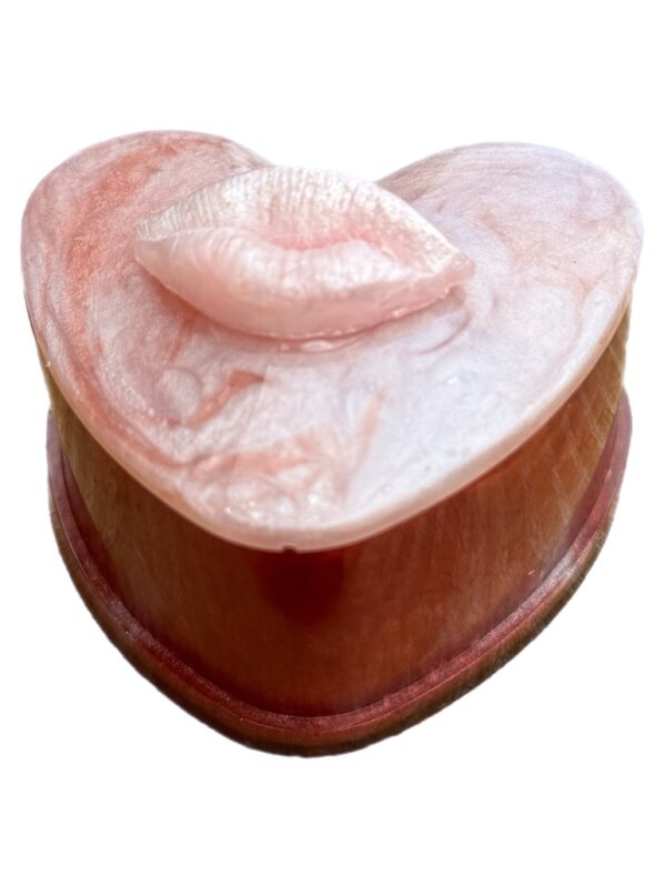 Heart-shaped resin trinket box with pearly lip lid in pink and red tones