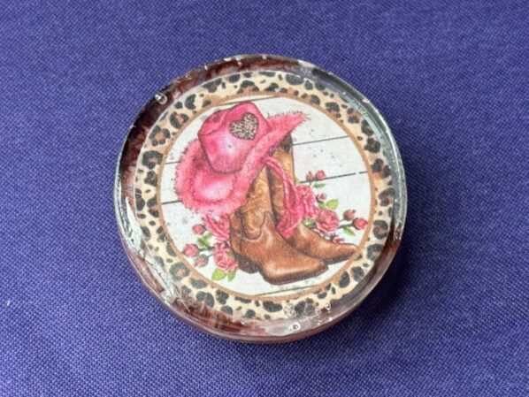 Top-down image of cowgirl resin phone grip, handmade with floral and western design